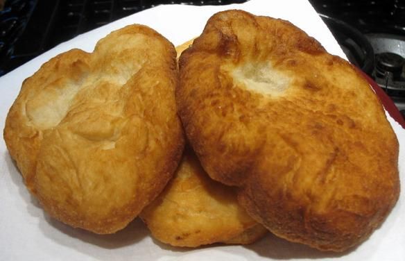 three pieces of bread sitting on top of a white napkin next to a black stove