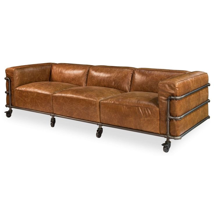 a brown leather couch sitting on top of a wooden table