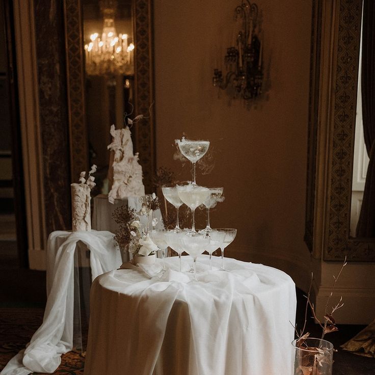 a table topped with two tiered cake covered in white frosting