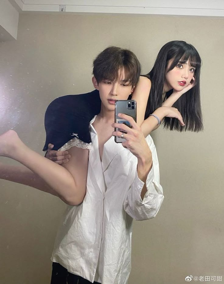 a man and woman taking a selfie in front of a mirror with their cell phones