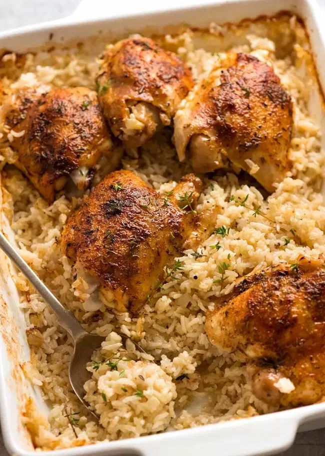 chicken and rice on a plate with a fork