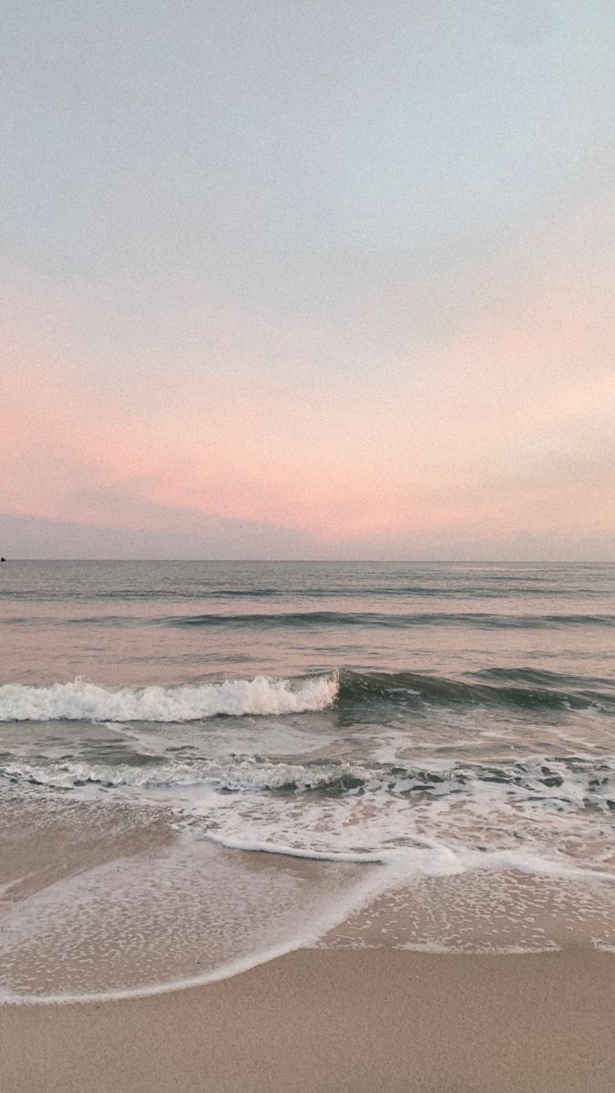 an ocean view with waves coming in to shore