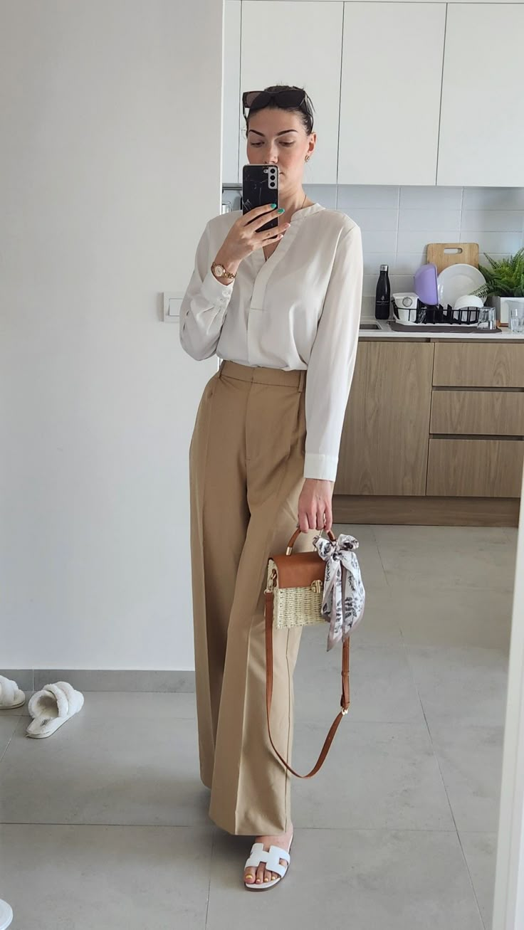 White blouse with long sleeve, beige high waist long pants, Hermes white slippers, Burberry brown sunglasses, summer outfit work office 2023 White Pants And Brown Top Outfit, Cream Beige Pants Outfit, How To Style Beige Formal Pants, High Waisted Pants Beige, White Blouse Formal Outfit, Cream Shirt Outfit Women Work, White Polo And Trousers Women, Beige Silk Shirt Outfit, Silk Fit Pants