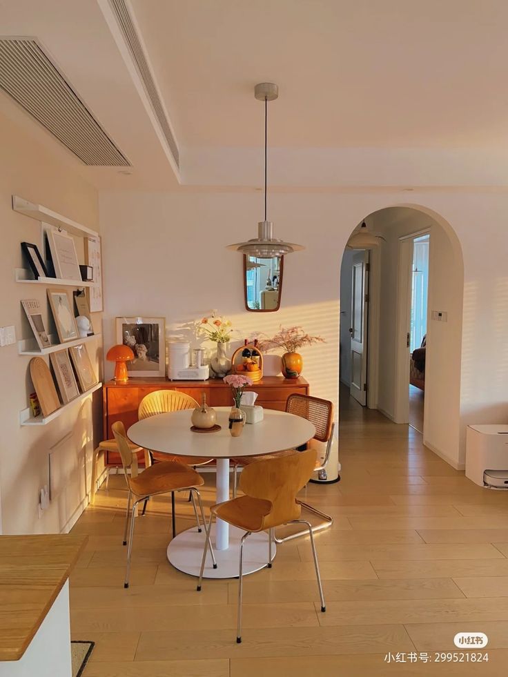 a dining room table and chairs in front of a doorway