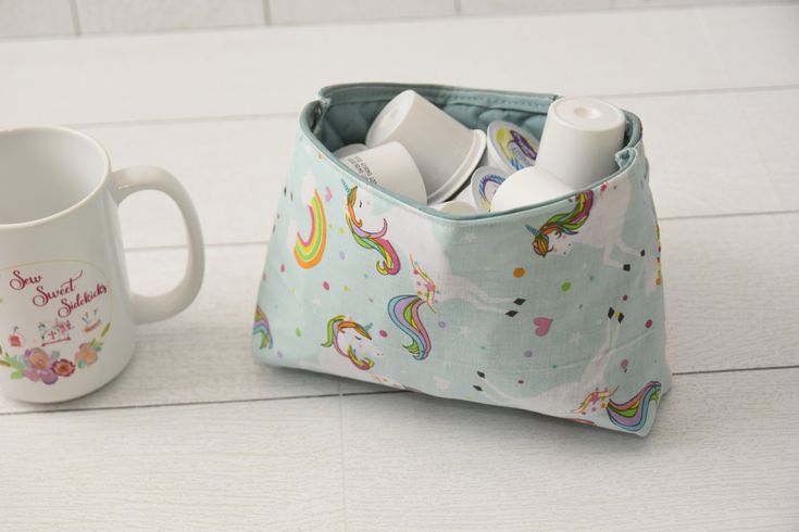 a cup with toothbrushes in it next to a bag