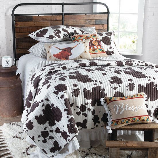 a bed with brown and white cow print on it