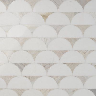 a white marble wall with circles on it