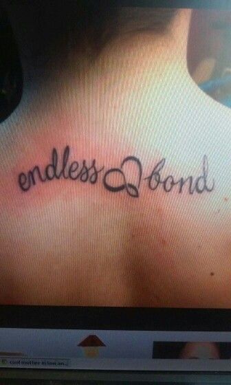 the back of a woman's neck with an inscription that says endless bond on it