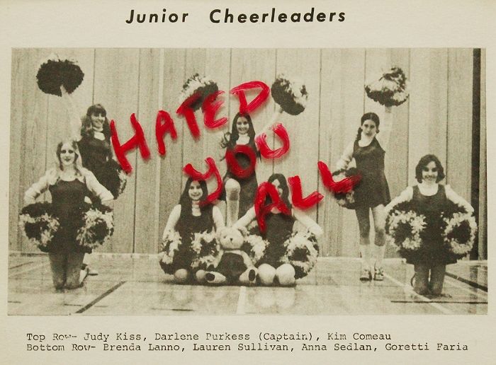 an old black and white photo with cheerleaders holding pom poms