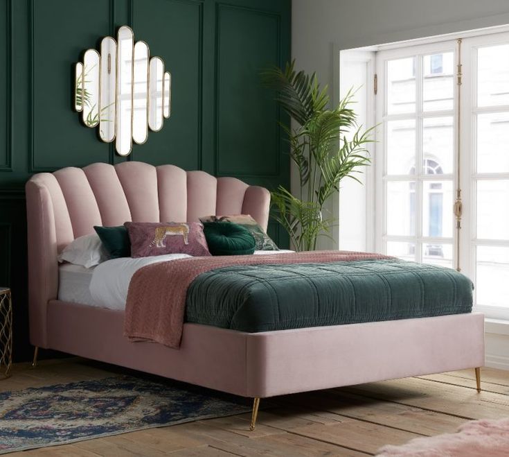 a bedroom with green walls and a pink bed in the middle, surrounded by rugs