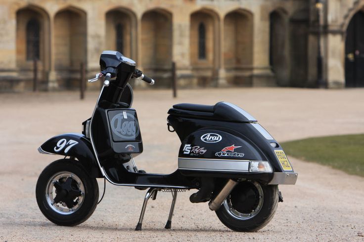 a black scooter parked in front of a building