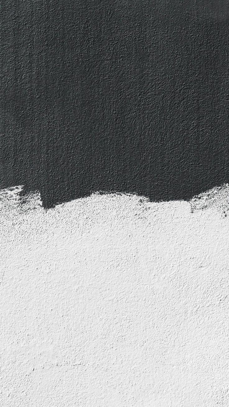 a black and white wall with some paint on it