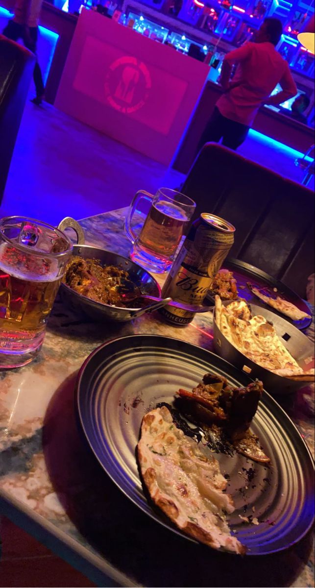 a table topped with plates and glasses filled with different types of food on top of it