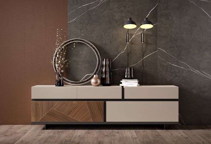 a modern style sideboard with two lamps and a mirror on the wall behind it