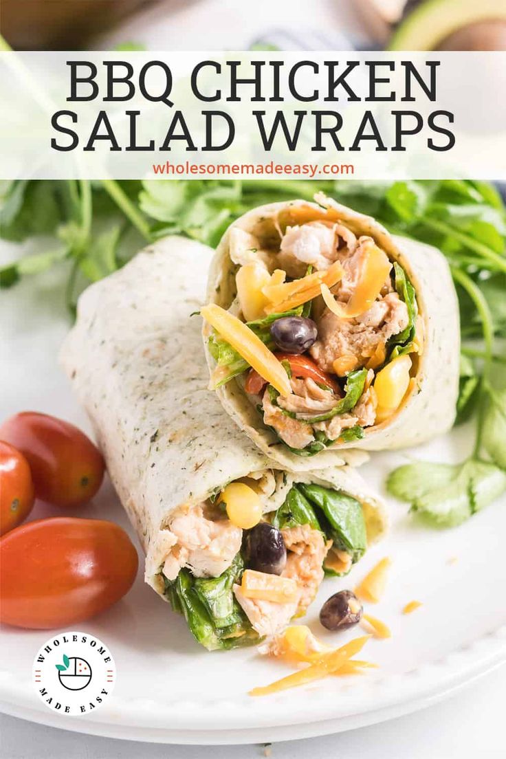 chicken salad wraps on a white plate with tomatoes and lettuce in the background