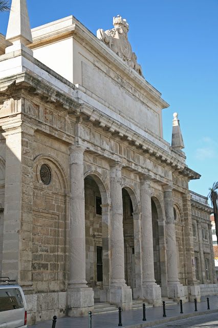 an old stone building with pillars and arches