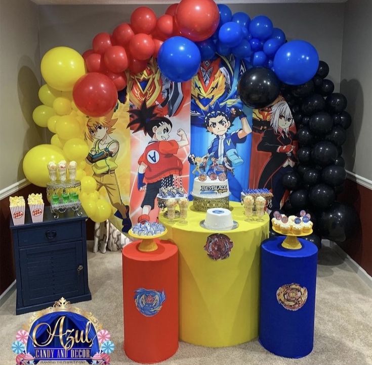 a table with balloons and decorations in the shape of anime characters, including dragon ballons