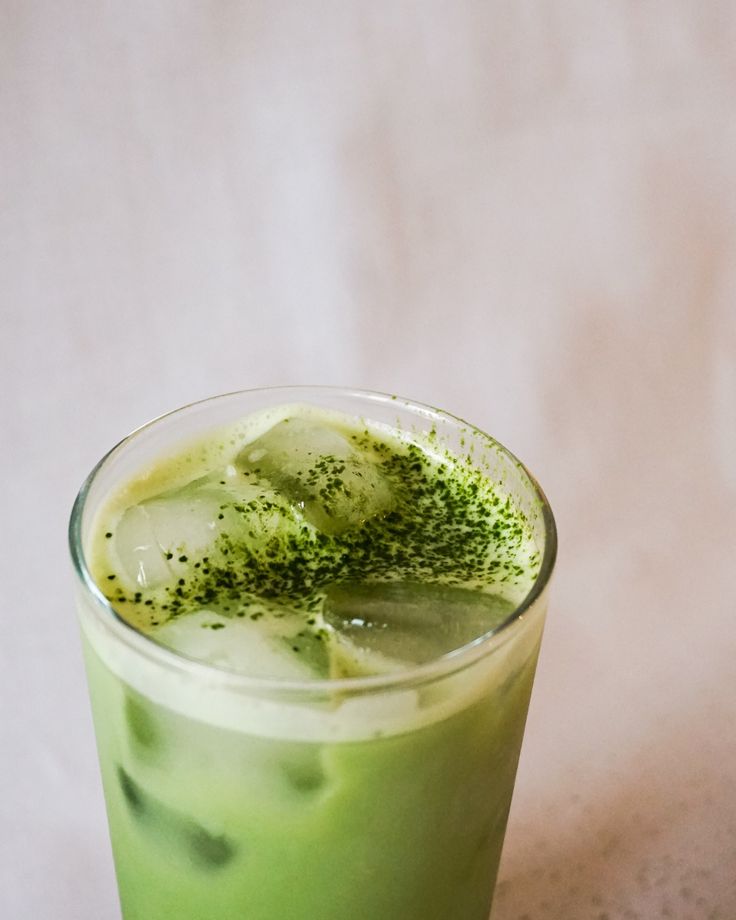 a green drink with ice and sprinkles