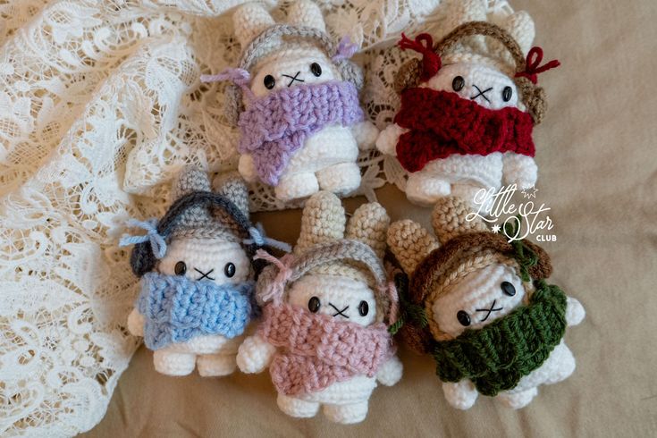 several small crocheted stuffed animals on a bed