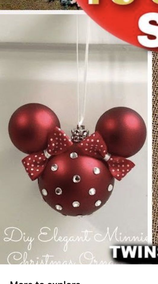 a minnie mouse ornament hanging from a string with polka dot bows on it