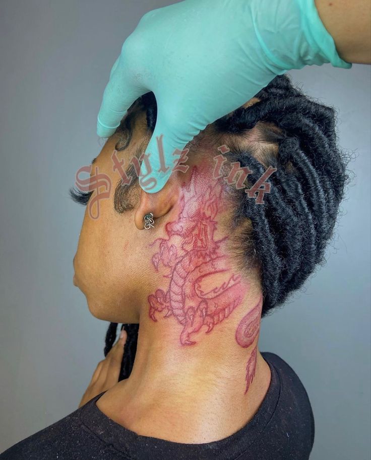 a man with a dragon tattoo on his neck is getting a haircut from a woman