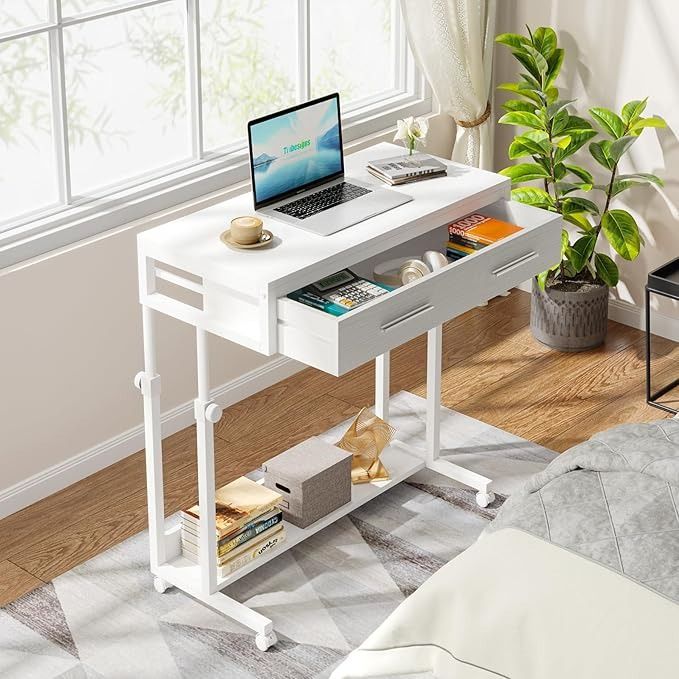 a laptop computer sitting on top of a white desk next to a plant in a living room