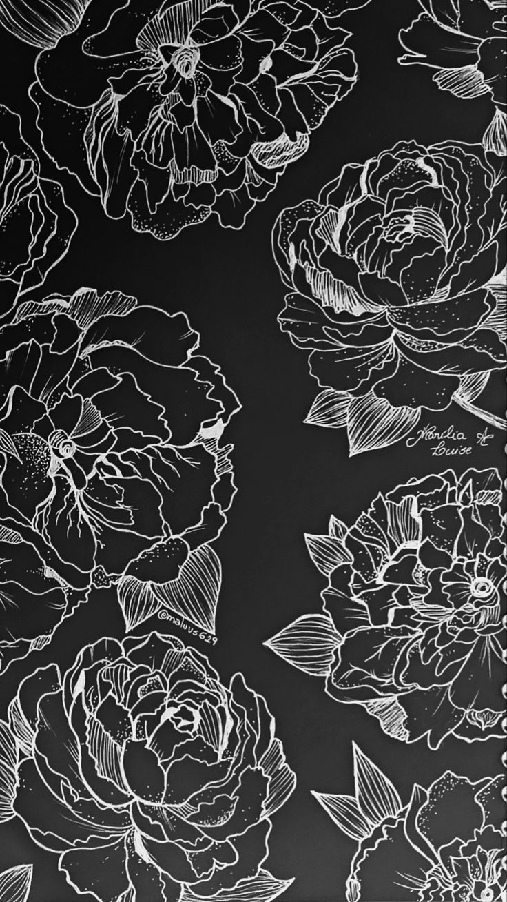 black and white drawing of flowers on a wall with chalkboard writing in the background