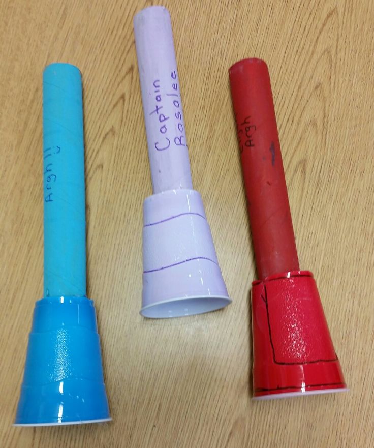 three different colored toilet paper tubes on a table