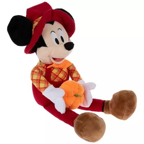 a mickey mouse stuffed animal holding a pumpkin