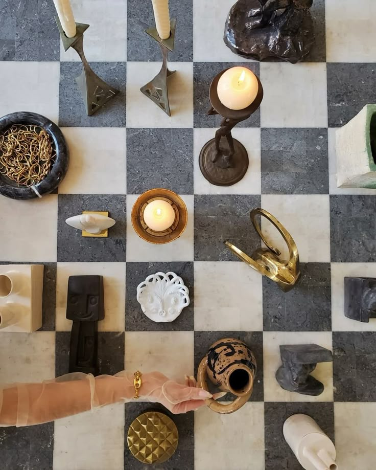 a checkered floor with candles and other items on it