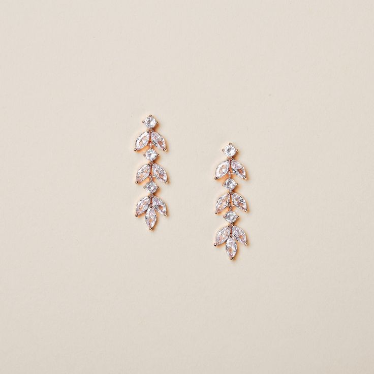 This pair of leaf-shaped crystal earrings are perfect for brides who prefer a low profile yet graceful look. It can also serve as daily earrings or the best gift for your bridesmaids. Details * Finish: Silver, Gold, or Rose gold * Measurement: 1/2 x 1 1/4 inches (1.2 x 3.2 cm) * Model is wearing rose gold. Shipping Information * Most items listed in my store are in stock and can be processed in 3-5 business days. For a few items that are temporarily out of stock or require longer processing time Bridal Dangle Earrings, Rose Gold Earrings Wedding, Gold Hair Vine, Gold Hair Pin, Dangle Earrings Wedding, Gold Earrings Wedding, Crystal Bridal Earrings, Bride Hair Accessories, Earrings Bridesmaid