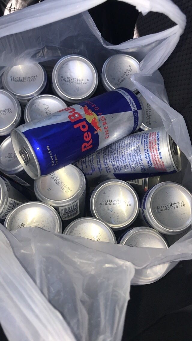 a bag full of soda cans sitting next to each other