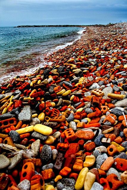 the beach is covered with rocks and pebbles