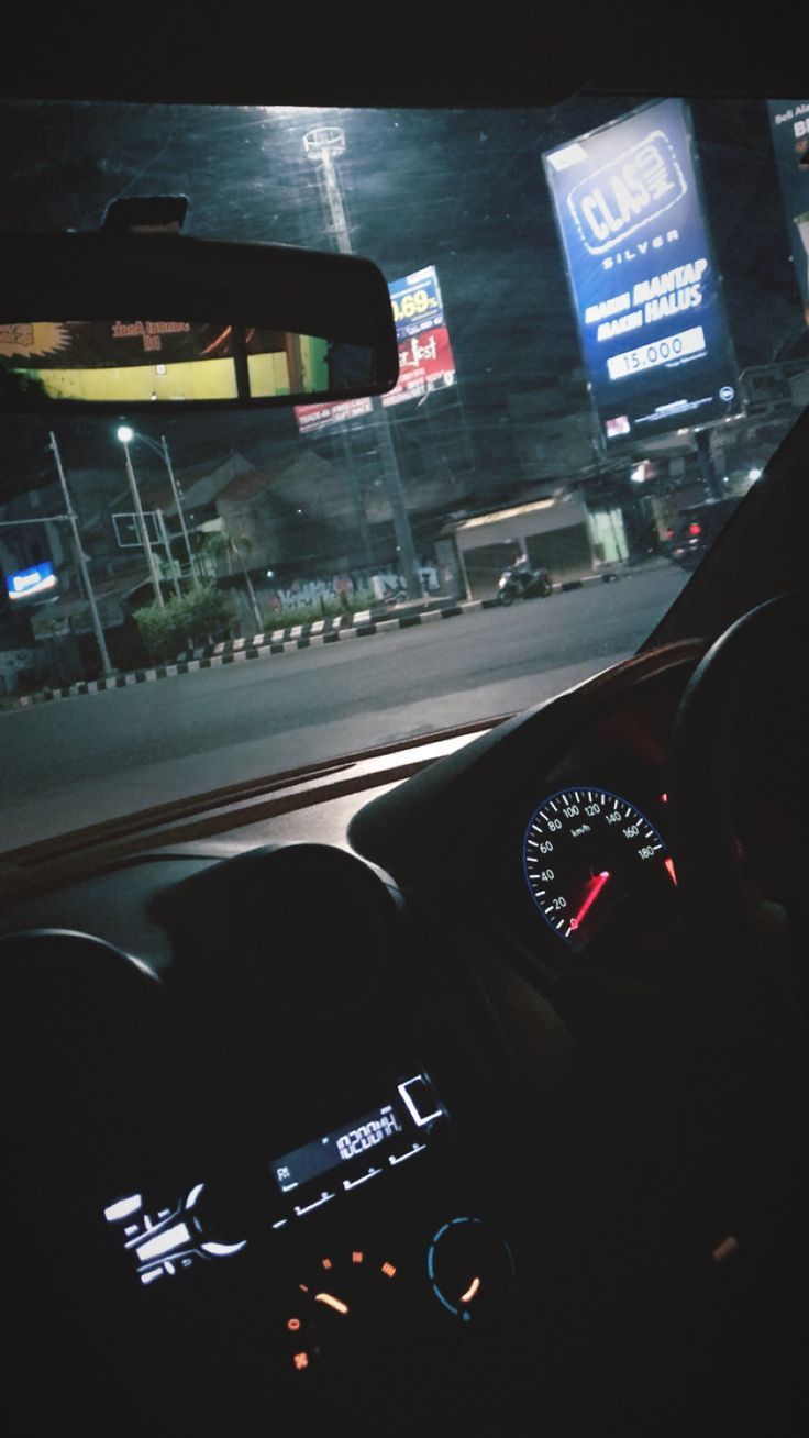 the dashboard of a car at night time