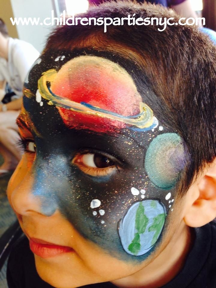 kid's face paint of solar system and space Solar System Face Paint, Solar System Painting, Face Painting Tips, Metallic Makeup, Galaxy Makeup, Face Painting Easy, Kids Face Paint, Space Birthday, Halloween Makeup Looks