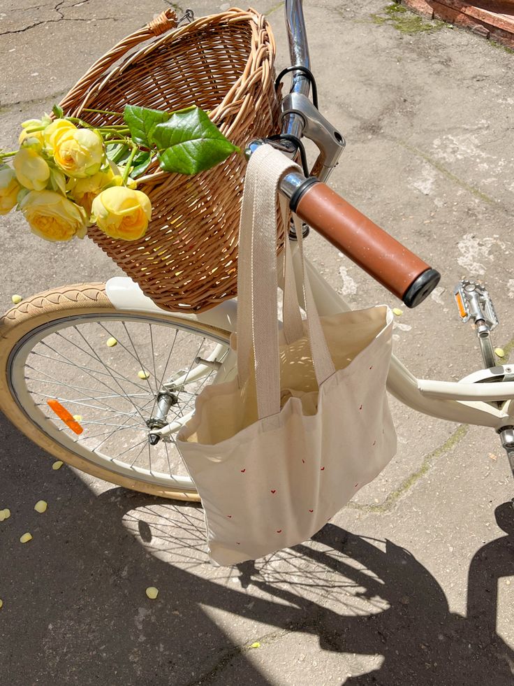 a bicycle with a basket full of yellow flowers