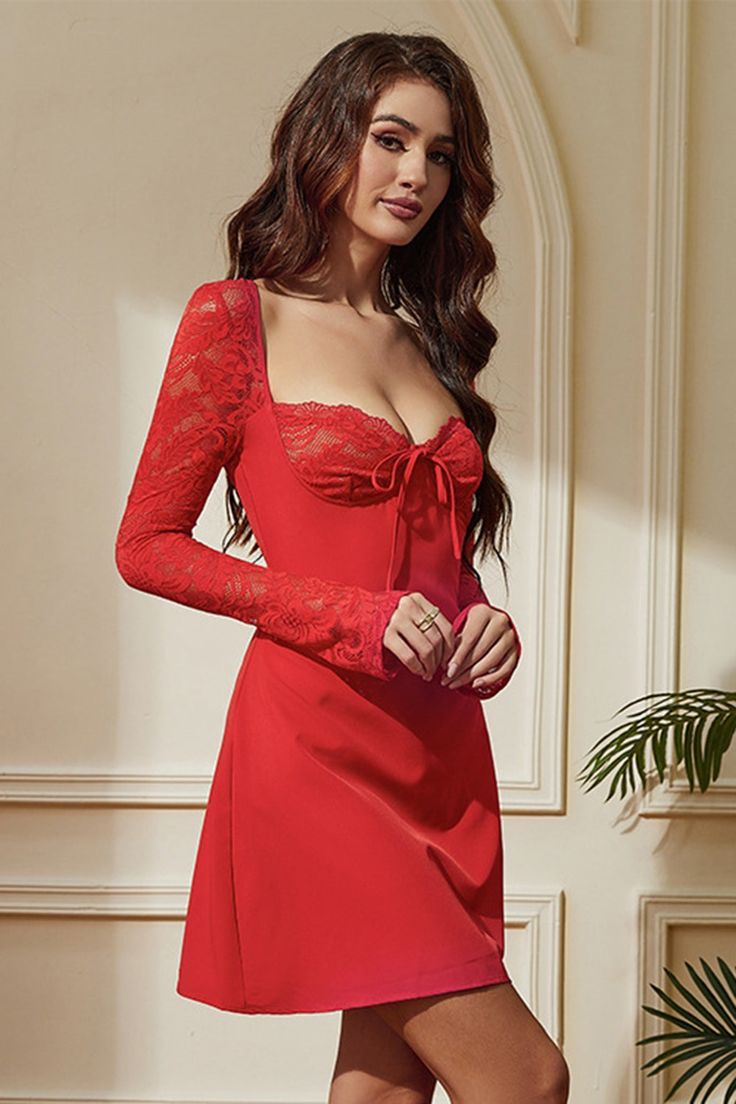 a woman in a red dress posing for the camera with her hands on her hips