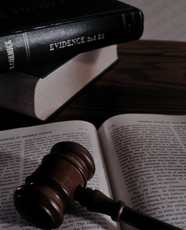 a judge's gavel sitting on top of an open book