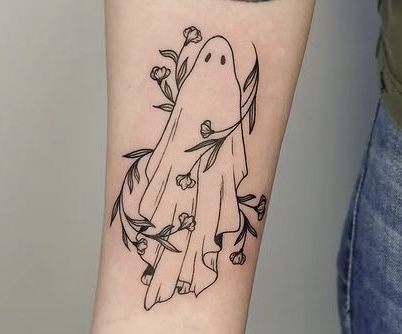 a black and white tattoo of a ghost with flowers on it's arm is shown