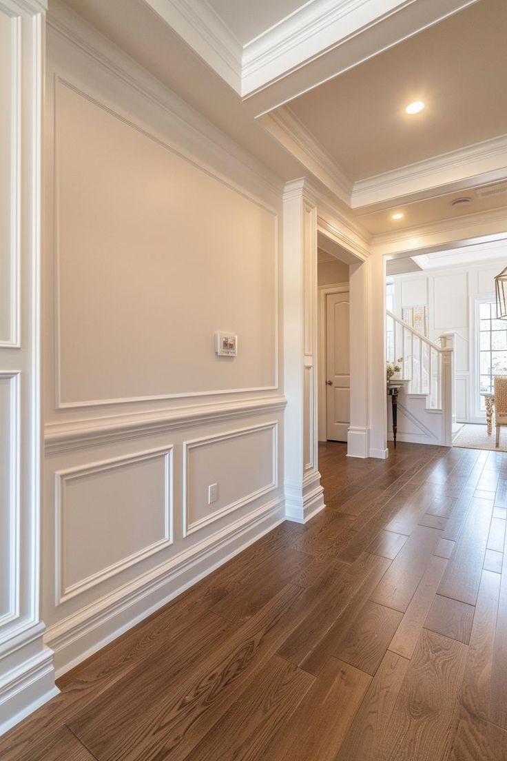 an empty living room with hard wood floors and white trim on the walls is shown