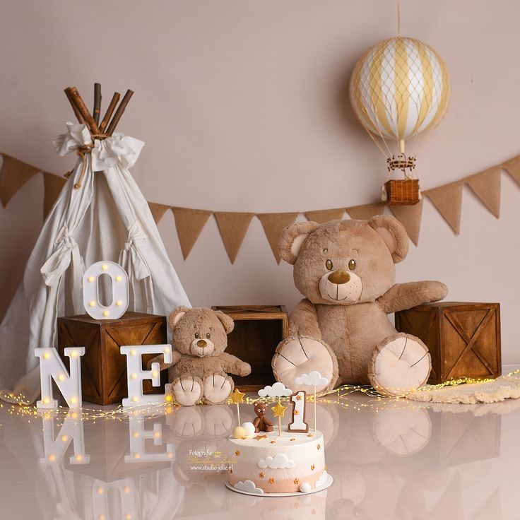 two teddy bears sitting next to each other in front of a cake