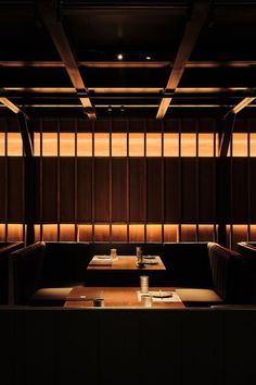 a dimly lit restaurant with wooden booths