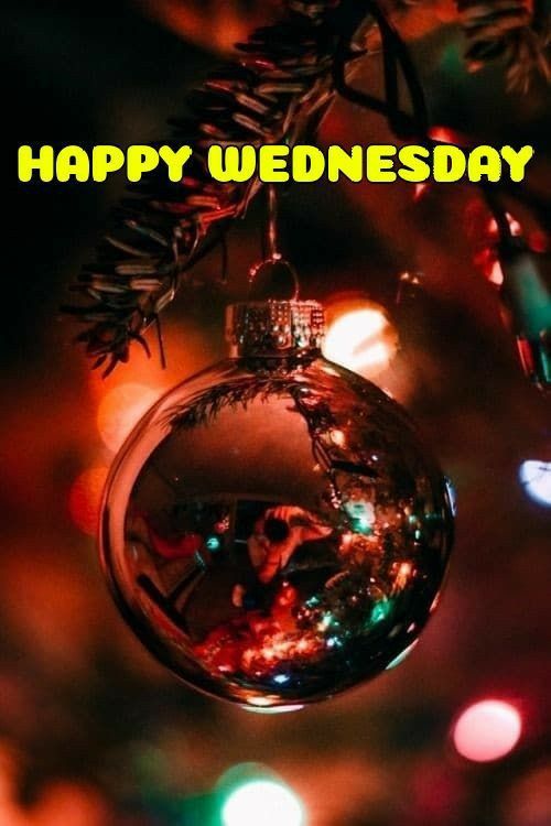 an ornament hanging from a christmas tree with the words happy wednesday on it