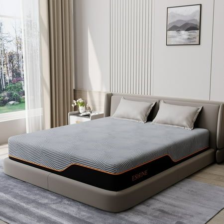 a bed sitting on top of a gray rug in a bedroom next to a window