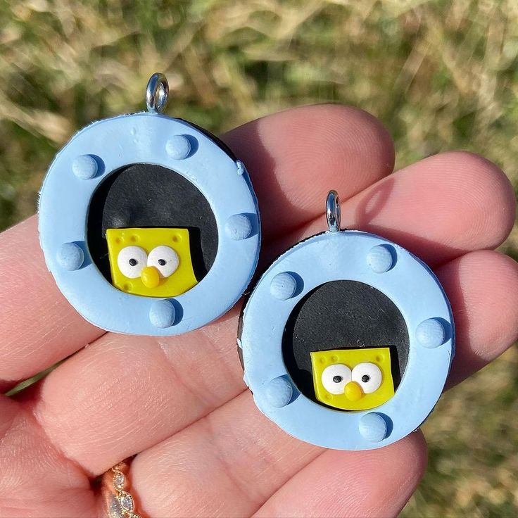 pair of earrings made to look like the simpsons character from the movie the simpsonss