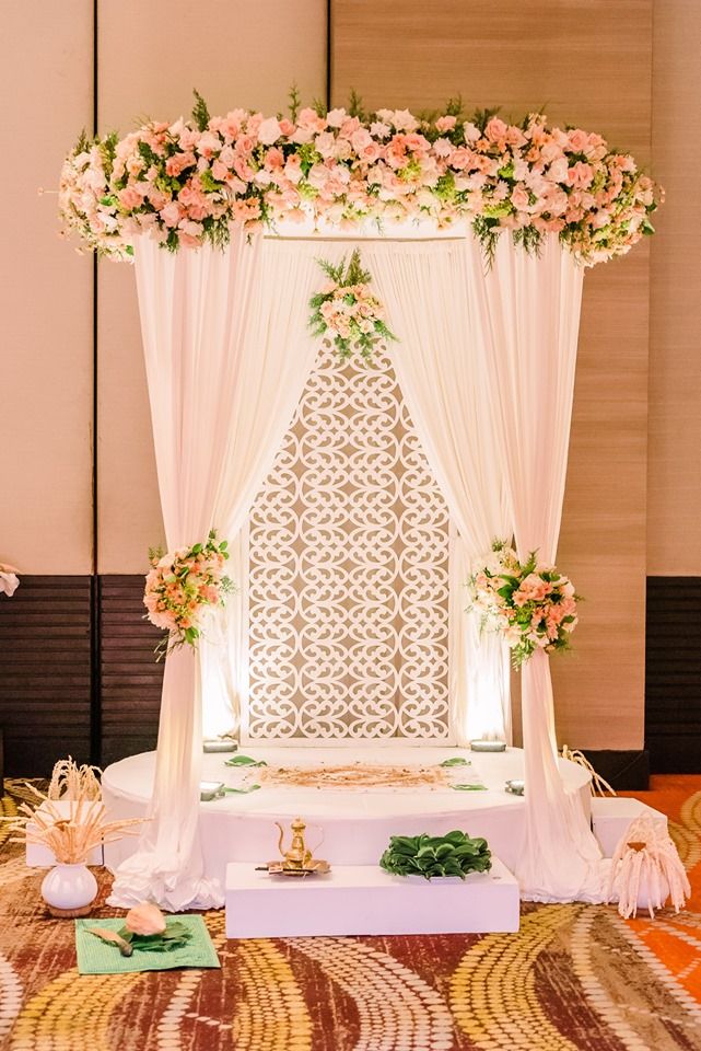 a decorated stage with flowers and candles on the side for a wedding ceremony or reception