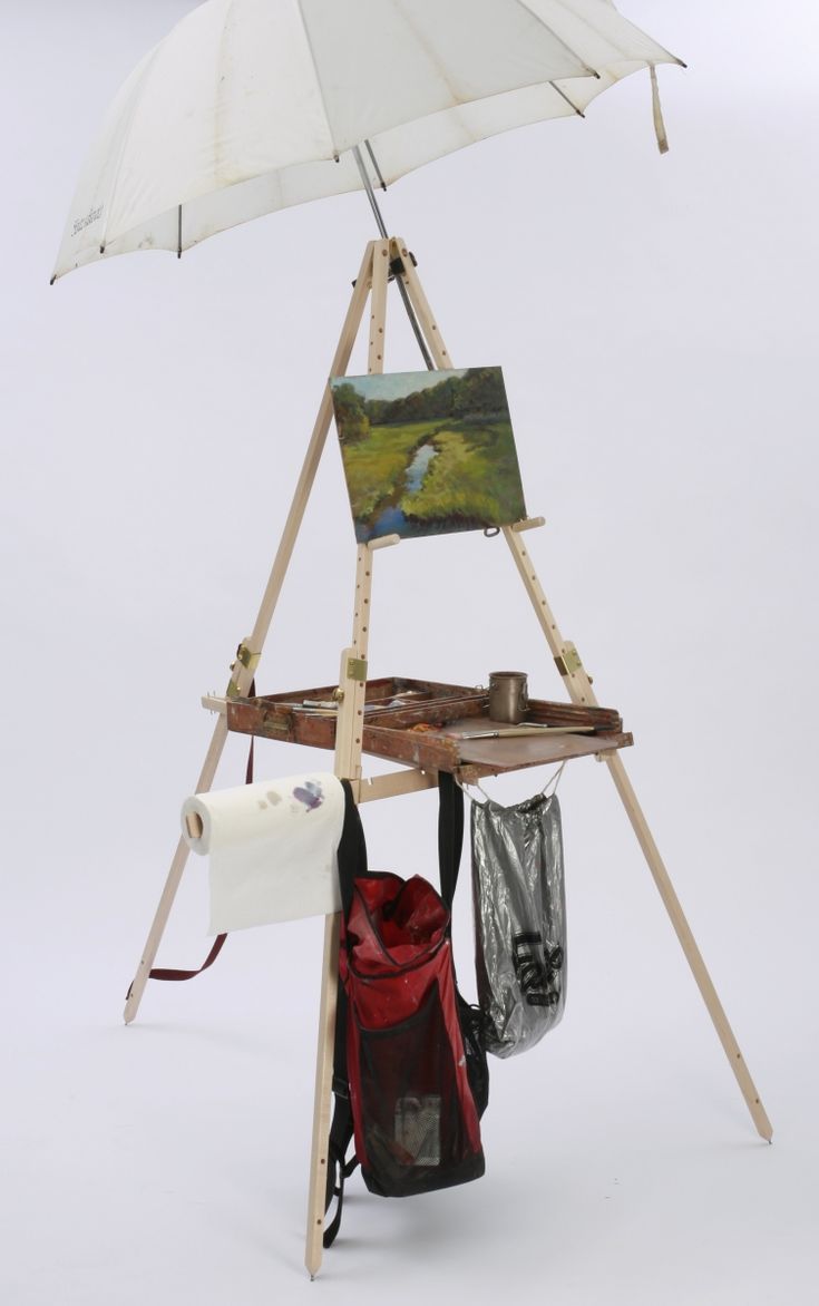 an umbrella and some bags on a stand