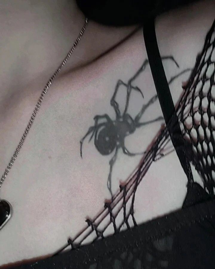 a black and white photo of a spider on the back of a woman's chest