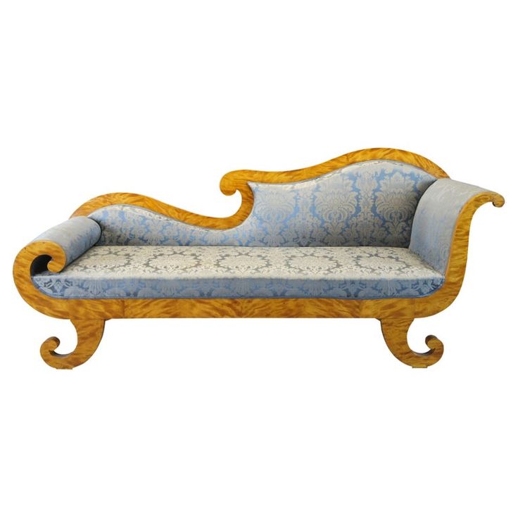 an ornately carved wooden couch with blue upholstered fabric