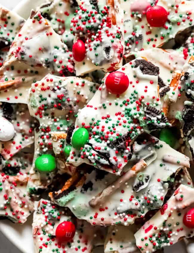 a white bowl filled with christmas crackers and candy canes on top of a table